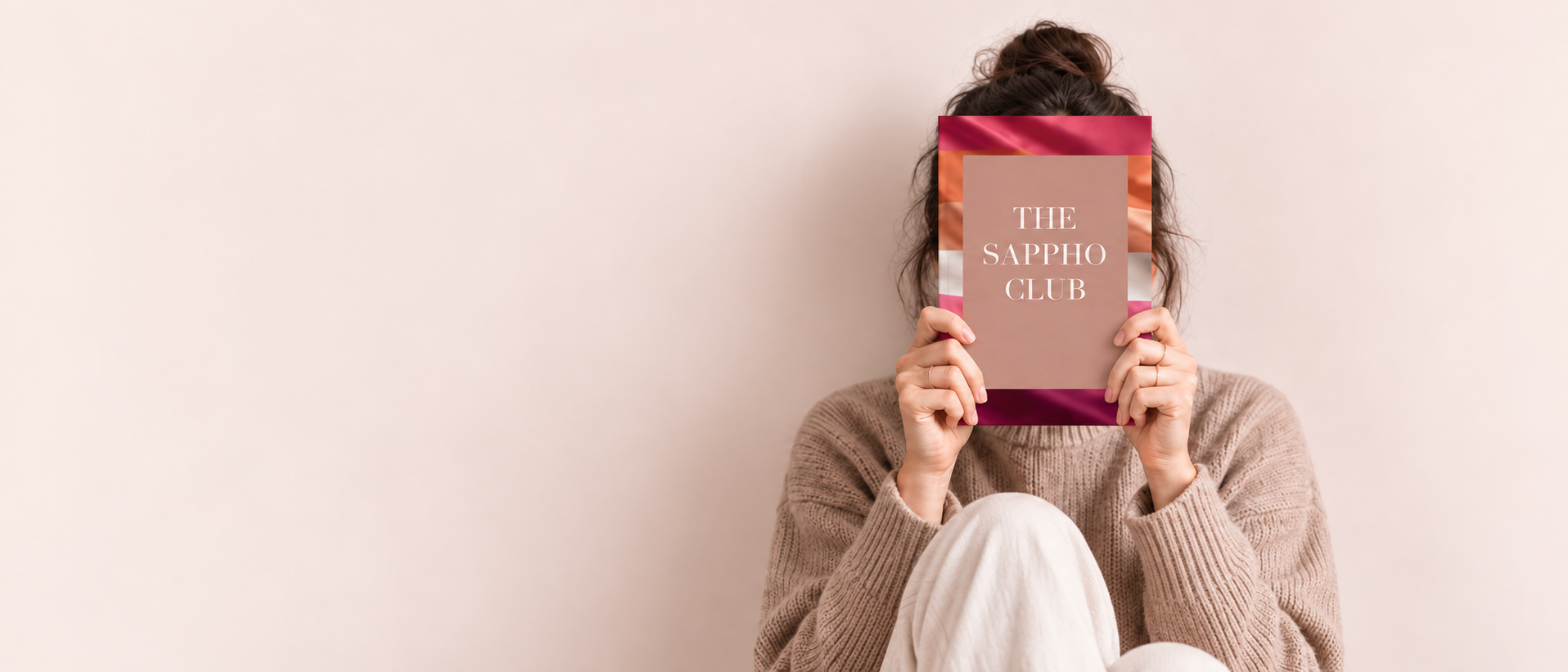 A reader holding The Sappho Club